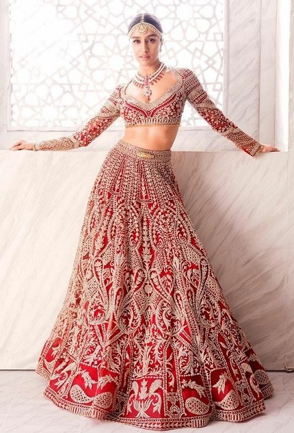Shraddha Kapoor looks resplendent in a deep red lehenga by Falguni Peacock & Shane Peacock accessorized with a stunning necklace by Narayan Jewellers